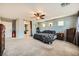 Main bedroom with carpeted floors, ensuite bathroom access, and ceiling fan at 10414 White Princess Ave, Las Vegas, NV 89166