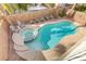 Overhead view of a kidney-shaped pool, spa, and surrounding patio at 11009 Pentland Downs St, Las Vegas, NV 89141