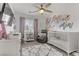 Bedroom with crib, armchair, and floral wall decal at 11009 Pentland Downs St, Las Vegas, NV 89141