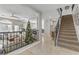 Elegant staircase with wrought-iron railing and a view of the living room at 11009 Pentland Downs St, Las Vegas, NV 89141