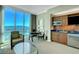 Living room features a kitchenette, seating area, and stunning city views at 125 E Harmon Ave # 3716, Las Vegas, NV 89109