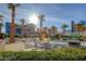 Inviting pool area with numerous lounge chairs and palm trees at 125 E Harmon Ave # 3716, Las Vegas, NV 89109