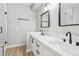 Modern bathroom featuring double sinks, white countertops, and a glass-enclosed shower with black trim at 2201 Ramsgate Dr # 327, Henderson, NV 89074