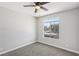 Cozy bedroom featuring plush carpet, a ceiling fan, and a bright window at 2201 Ramsgate Dr # 327, Henderson, NV 89074