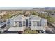 Attractive condo building featuring a tile roof, covered parking, and beautiful desert landscaping at 2201 Ramsgate Dr # 327, Henderson, NV 89074