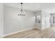 Bright living area with wood-look flooring, a modern chandelier, and a large window at 2201 Ramsgate Dr # 327, Henderson, NV 89074