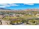 Aerial view of houses, golf course, and lake at 5 Moonfire Dr, Las Vegas, NV 89135