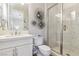 Clean bathroom with white vanity, a large mirror and a walk-in shower at 5 Moonfire Dr, Las Vegas, NV 89135