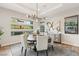 Elegant dining room features a large round table and statement art at 5 Moonfire Dr, Las Vegas, NV 89135