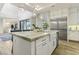 Bright kitchen with white cabinetry, granite island, and stainless steel appliances at 5 Moonfire Dr, Las Vegas, NV 89135