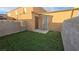 Artificial turf backyard with storage shed and block wall at 6311 W Washington Ave, Las Vegas, NV 89107