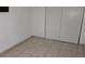 Small bedroom with tiled floors and closet at 6311 W Washington Ave, Las Vegas, NV 89107