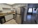 Stainless steel refrigerator and dishwasher in a kitchen with granite countertops at 6311 W Washington Ave, Las Vegas, NV 89107