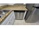 Close-up of a stainless steel dishwasher in a kitchen with granite countertops at 6311 W Washington Ave, Las Vegas, NV 89107