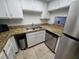 Kitchen with granite countertops, white cabinets, and stainless steel appliances at 6311 W Washington Ave, Las Vegas, NV 89107