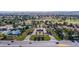 A vibrant aerial view of a well-maintained community featuring a golf course, tennis courts, and lush landscaping at 7327 Mission Hills Dr # 0, Las Vegas, NV 89113