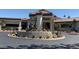 Exterior view of the community clubhouse featuring desert landscaping and a circular driveway at 7327 Mission Hills Dr # 0, Las Vegas, NV 89113