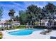 Community pool with poolside seating, lush landscaping, and nearby residences at 7327 Mission Hills Dr # 0, Las Vegas, NV 89113