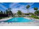 Community pool with lounge chairs and well-kept landscape and palm trees at 7327 Mission Hills Dr # 0, Las Vegas, NV 89113