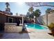 Inviting backyard oasis with sparkling pool, built-in BBQ, and covered patio at 7393 Puritan Ave, Las Vegas, NV 89123