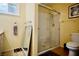 Bathroom with walk-in shower, toilet, and linen storage at 7393 Puritan Ave, Las Vegas, NV 89123