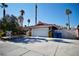 Home's exterior features a white garage door and a paved driveway at 7393 Puritan Ave, Las Vegas, NV 89123