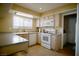 Modern kitchen with white appliances and wood cabinets at 7393 Puritan Ave, Las Vegas, NV 89123