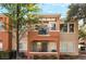 Exterior view of a two-story condo unit, showcasing the covered patio and balcony at 10710 Destination Ln # 201, Las Vegas, NV 89144