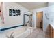 Bathroom showcasing a soaking tub with glass shower door and blue tile accents at 10710 Destination Ln # 201, Las Vegas, NV 89144