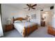 Bright bedroom features a wooden bed frame, ceiling fan, and neutral decor at 10710 Destination Ln # 201, Las Vegas, NV 89144