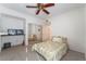 Cozy bedroom featuring a ceiling fan and mirrored closet doors at 10710 Destination Ln # 201, Las Vegas, NV 89144