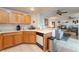 Cozy kitchen with wood cabinets flowing into the adjacent living room at 10710 Destination Ln # 201, Las Vegas, NV 89144