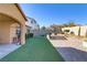 Artificial turf backyard with stone and brick paved patio at 12270 Monument Hill Ave, Las Vegas, NV 89138