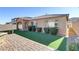 Spacious backyard with artificial turf and brick paved patio at 12270 Monument Hill Ave, Las Vegas, NV 89138