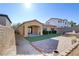 Artificial turf backyard with paved patio and a covered area at 12270 Monument Hill Ave, Las Vegas, NV 89138