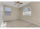 Bright bedroom with large window and ceiling fan at 12270 Monument Hill Ave, Las Vegas, NV 89138