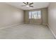 Spacious bedroom with window and ceiling fan at 12270 Monument Hill Ave, Las Vegas, NV 89138