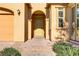 Front entry with light-colored door and brick walkway at 12270 Monument Hill Ave, Las Vegas, NV 89138