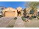 One-story house with a two-car garage and landscaped front yard at 12270 Monument Hill Ave, Las Vegas, NV 89138