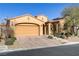 Tan two-story house with a double-car garage and landscaped yard at 12270 Monument Hill Ave, Las Vegas, NV 89138