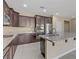 Modern kitchen with dark cabinets, granite countertops, and island at 12270 Monument Hill Ave, Las Vegas, NV 89138