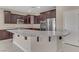 Modern kitchen with dark cabinets, granite countertops, and island at 12270 Monument Hill Ave, Las Vegas, NV 89138