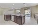 Modern kitchen with island, granite countertops and stainless steel appliances at 12270 Monument Hill Ave, Las Vegas, NV 89138