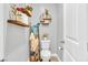 Small bathroom with floating shelves, ladder towel rack, and white toilet at 145 Langley Hill Ave, Henderson, NV 89002