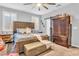 King-size bed, barn door, and large wooden dresser in this cozy Primary bedroom at 145 Langley Hill Ave, Henderson, NV 89002