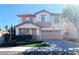 Charming two-story home featuring a tile roof, a two-car garage, and a well-maintained lawn at 319 Fox Lake Ave, Las Vegas, NV 89148