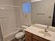 Clean bathroom with tub, toilet and wood vanity at 3367 Villa Fiori Ave, Las Vegas, NV 89141