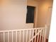 Upper hallway with white railing and access to bedrooms at 3367 Villa Fiori Ave, Las Vegas, NV 89141