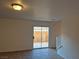 Living room with tile floors and sliding glass doors to backyard at 3367 Villa Fiori Ave, Las Vegas, NV 89141