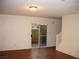 Living room with tile floor, sliding glass door, and staircase at 3367 Villa Fiori Ave, Las Vegas, NV 89141